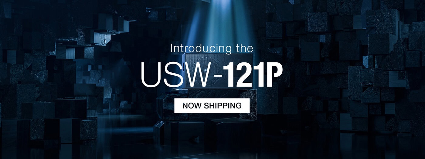 Der Text lautet Einführung des USW-121P. Jetzt Shipping vor einem dunklen, geometrischen Hintergrund mit blauer Beleuchtung und einem Scheinwerfer auf den Produktnamen.